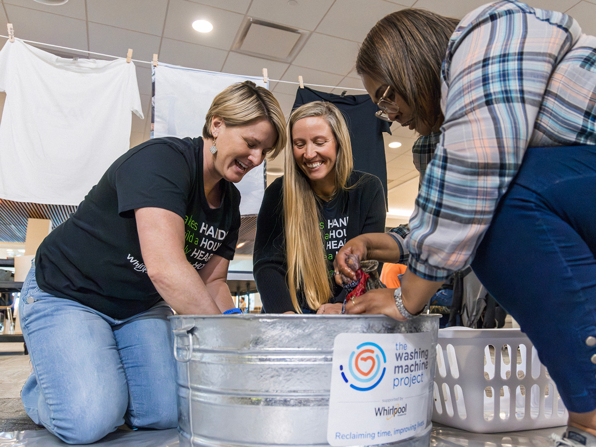 Whirlpool Corporation employees hand washing clothes
