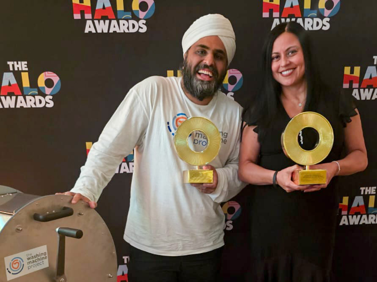 Nav and Rosa holding gold halo award